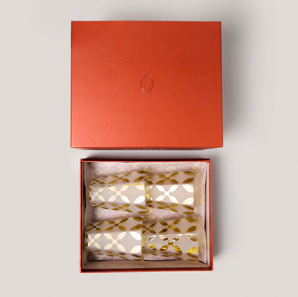 Top-down view of The Diamond Glasses Gift Box with four handblown hexagonal tumblers with matte finish and yellow appliqué