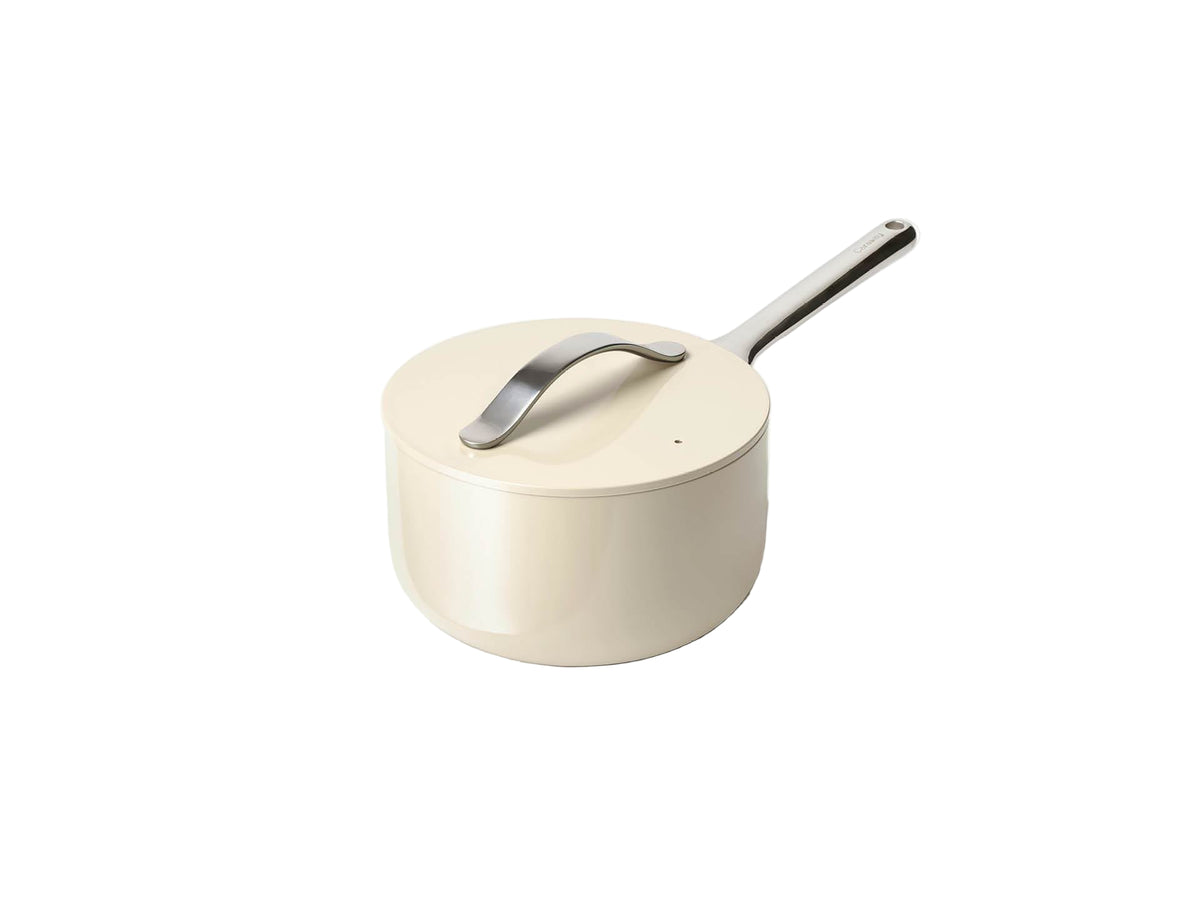 Three-quarter view of 3-qt cream sauce pan showcasing stainless steel handle and matching lid on white background
