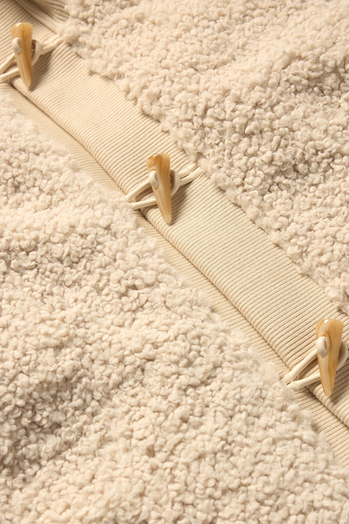 Close up to sherpa material and elevated buttons 