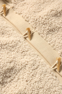 Close up to sherpa material and elevated buttons 