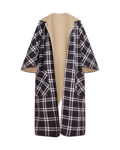 Front view of Carlisle reversible coat in Dark Fig Plaid showcasing plaid exterior, tan reverse, hood, buttons, and front pockets on white