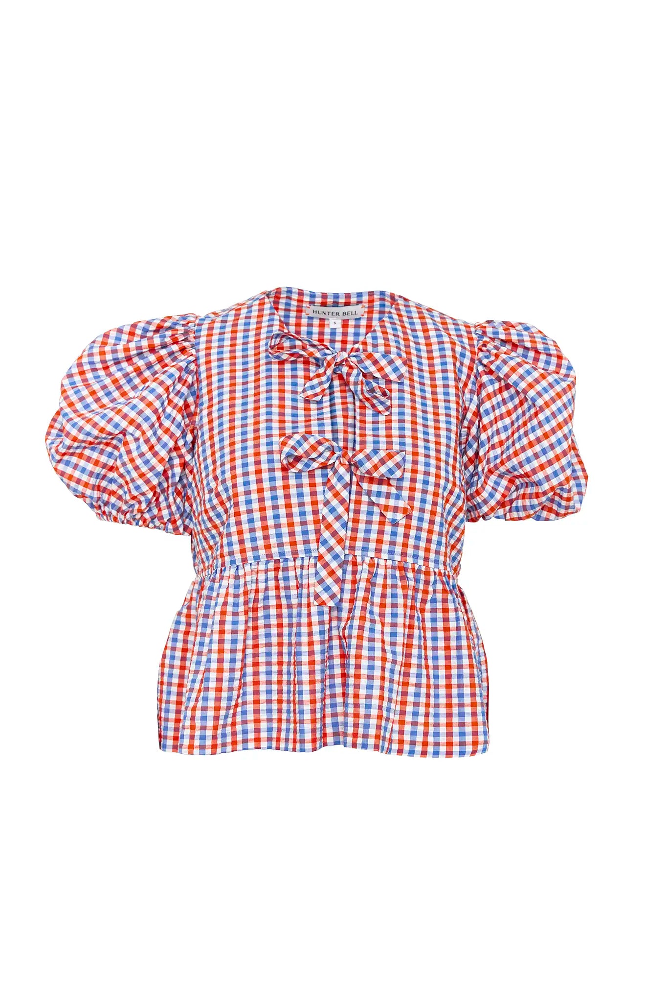 The Carly Top has a crew neck, full balloon sleeves with soft elastic cuffs, and front tie closure.