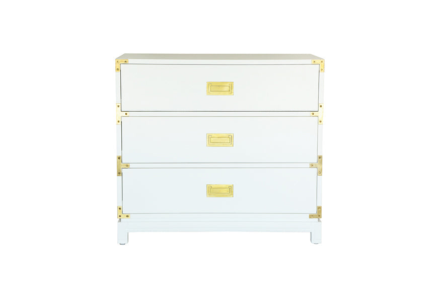 Front view of Small Carlyle Campaign dresser in white with three drawers, recessed brass pulls, and corner brackets