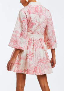 Linen mini dress with butterfly sleeves, hand pockets, and front bow detail. Featuring a mandarin collar and a pink toile print. 