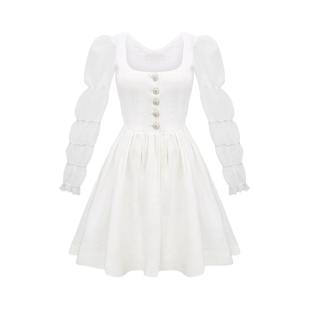 Front view of Carolina Dress in White showcasing puffed sleeves, antique buttons, and gathered skirt with a plain white background
