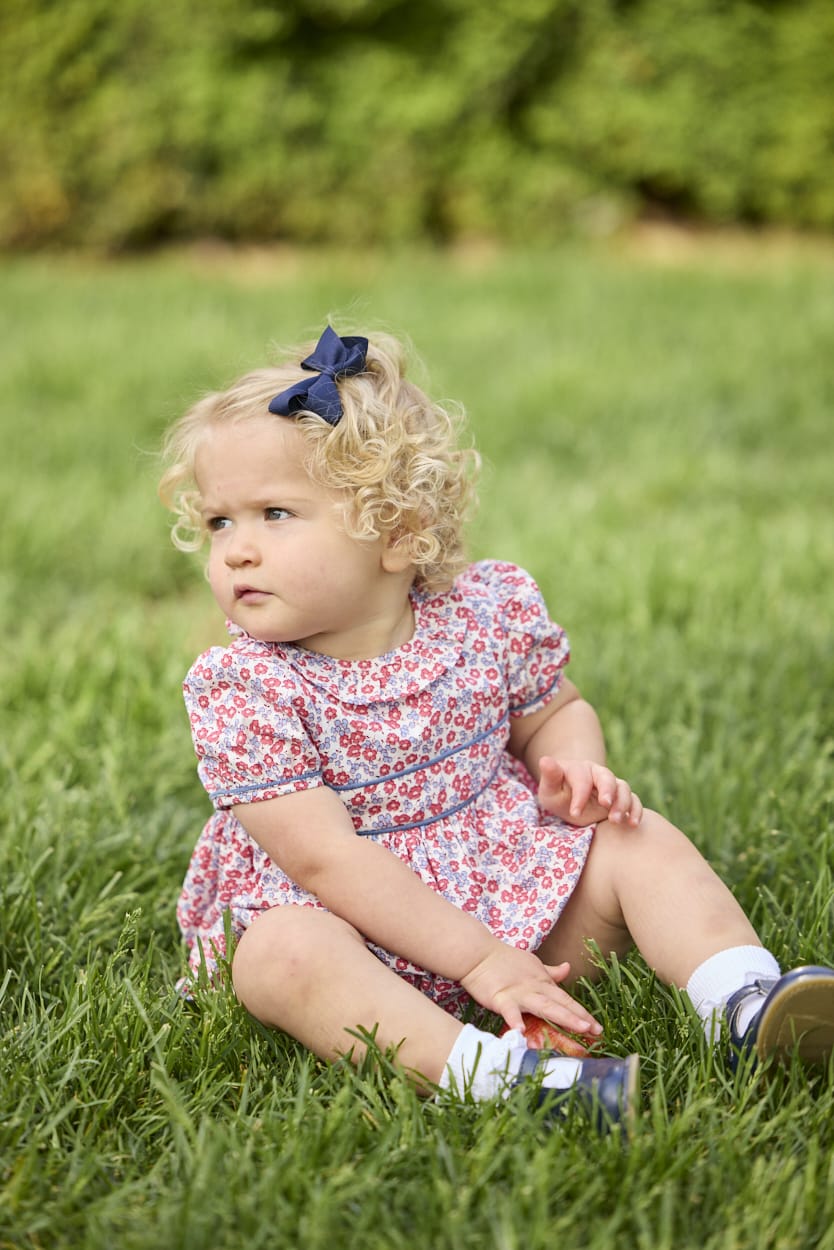 Little English traditional children's clothing.  Soft blue and raspberry red Lennox Floral short sleeve bubble for baby girls with ruffle collar and blue piping detail at sleeves and chest