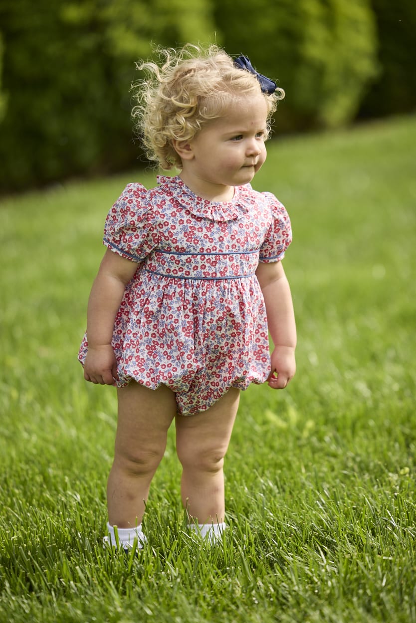 Little English traditional children's clothing.  Soft blue and raspberry red Lennox Floral short sleeve bubble for baby girls with ruffle collar and blue piping detail at sleeves and chest