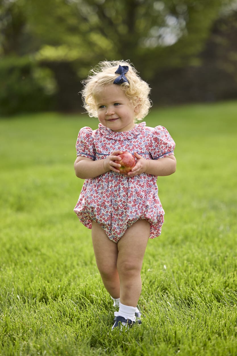 Little English traditional children's clothing.  Soft blue and raspberry red Lennox Floral short sleeve bubble for baby girls with ruffle collar and blue piping detail at sleeves and chest