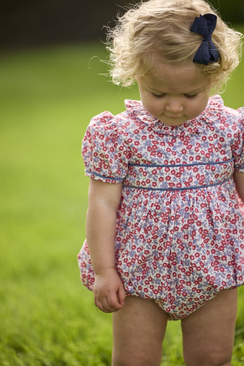 Little English traditional children's clothing.  Soft blue and raspberry red Lennox Floral short sleeve bubble for baby girls with ruffle collar and blue piping detail at sleeves and chest