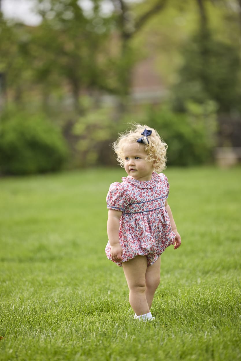 Little English traditional children's clothing.  Soft blue and raspberry red Lennox Floral short sleeve bubble for baby girls with ruffle collar and blue piping detail at sleeves and chest
