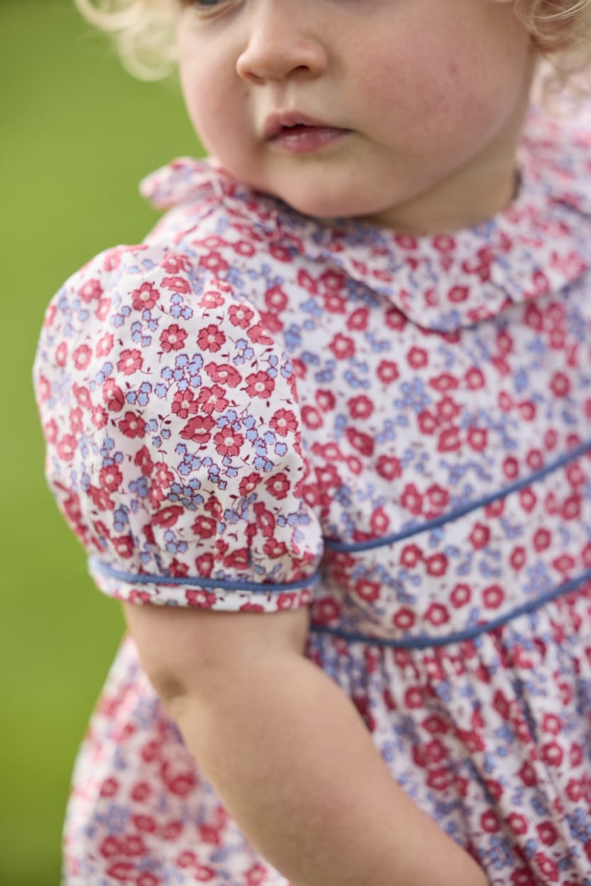 Little English traditional children's clothing.  Soft blue and raspberry red Lennox Floral short sleeve bubble for baby girls with ruffle collar and blue piping detail at sleeves and chest