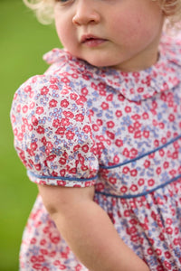 Little English traditional children's clothing.  Soft blue and raspberry red Lennox Floral short sleeve bubble for baby girls with ruffle collar and blue piping detail at sleeves and chest