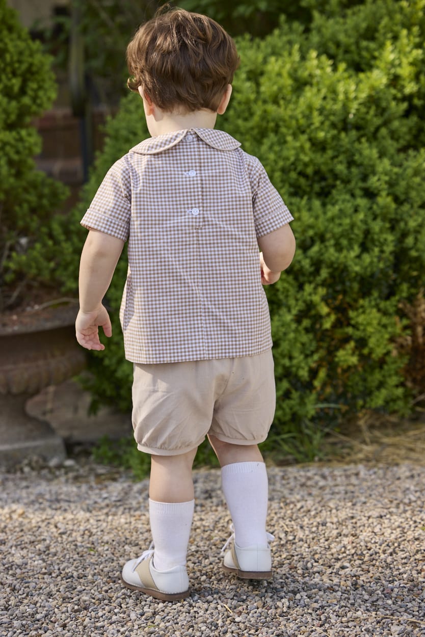 Little English traditional children's clothing.  Short sleeve pleated peter pan shirt in khaki gingham paired with khaki stone corduroy banded shorts.  Fall set for toddler boys.