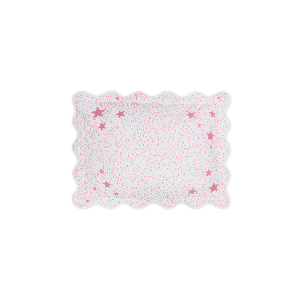 Top-down view of Celine Stars mini boudoir pillow showcasing pink star pattern and scalloped edge on black background