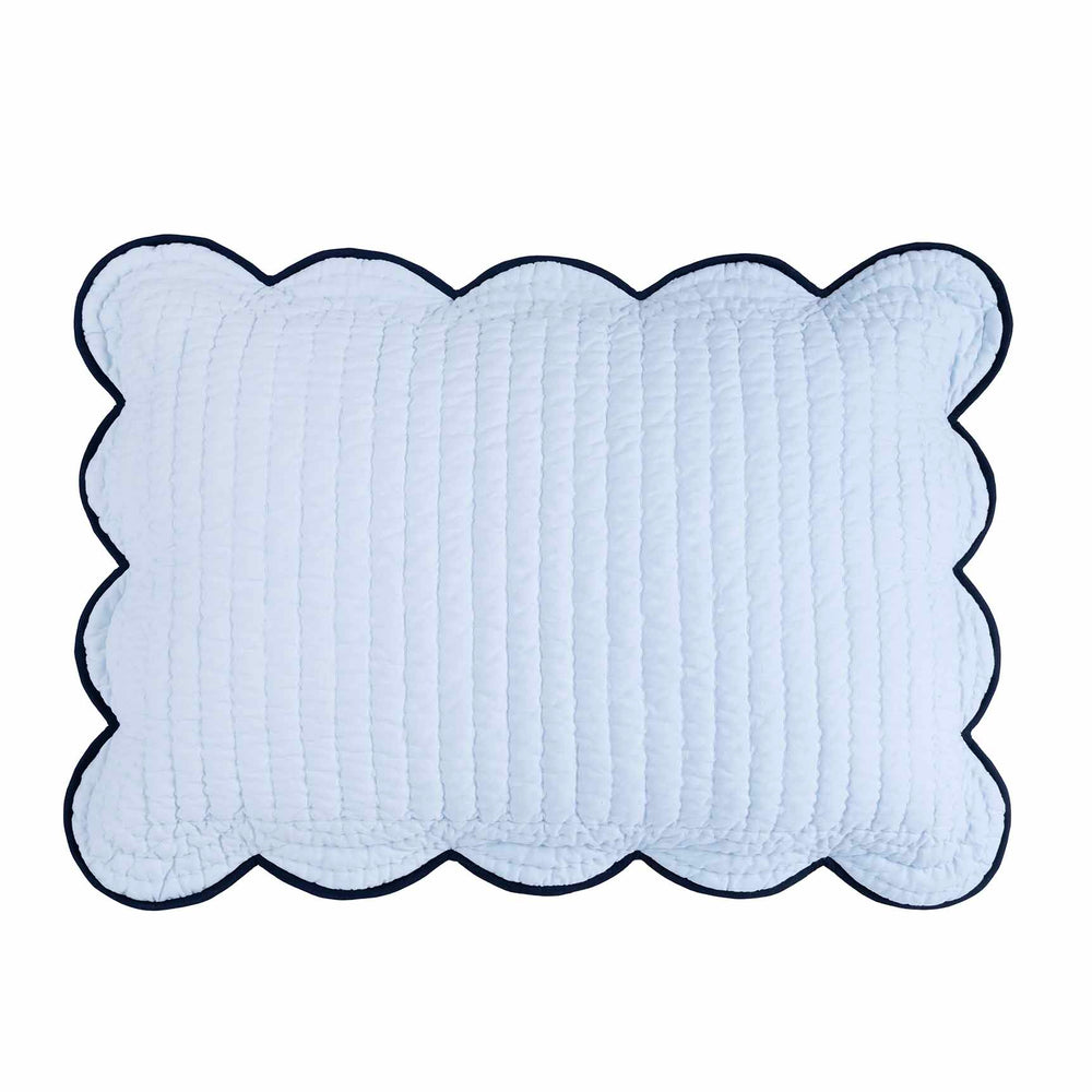 Top view of Chairish cotton sham showcasing scalloped navy contrast edge and vertical hand-stitched quilting on white background