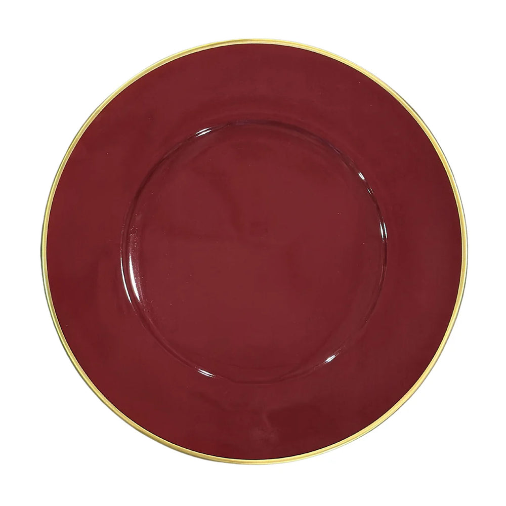 Top-down view of a crimson porcelain charger plate with a gold rim on white background