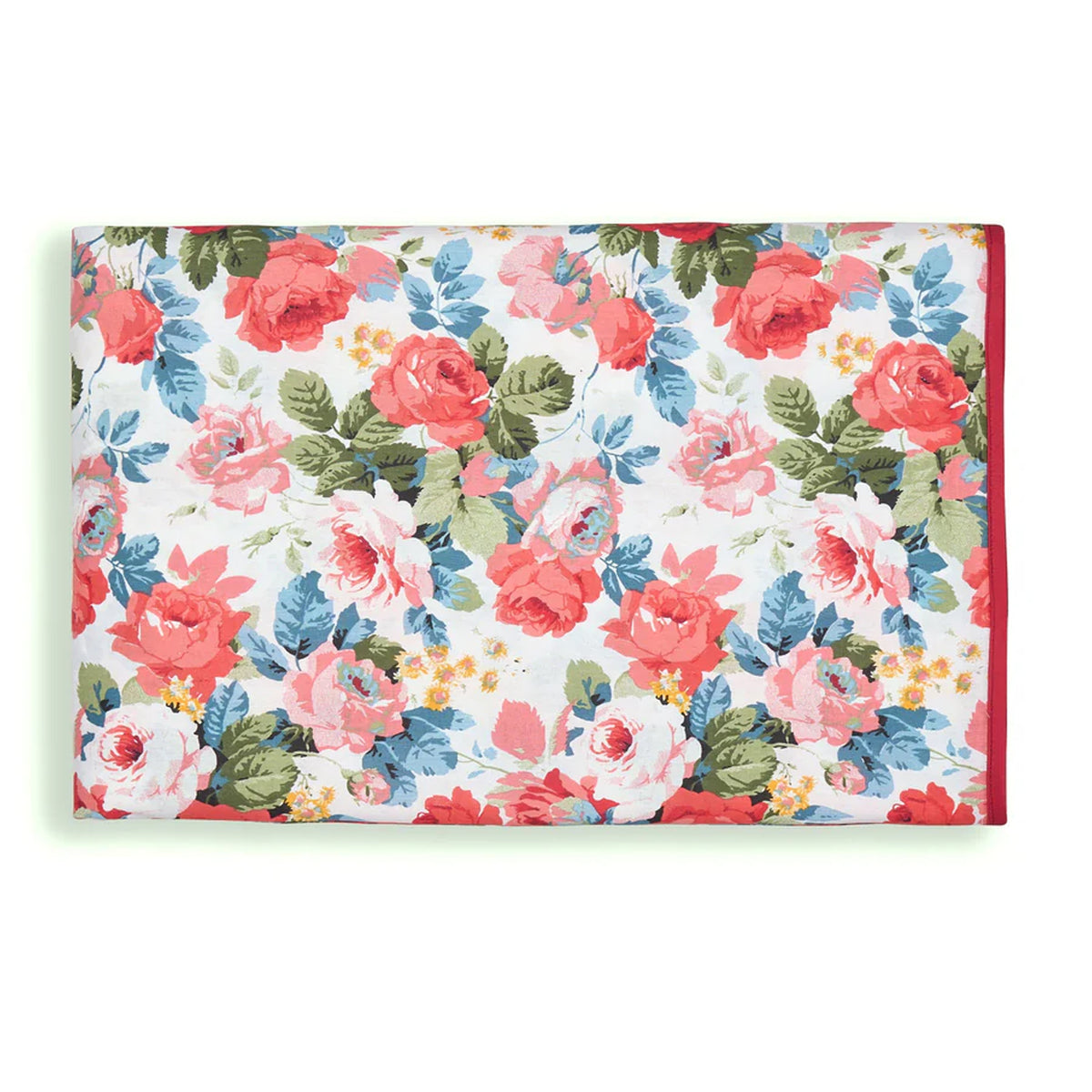 Folded Charlotte tablecloth showcasing coral and pink rose floral print with blue and green leaves on white background