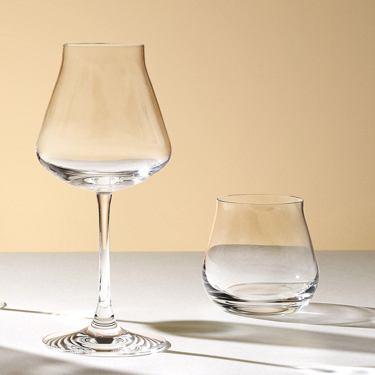 Front view of Chateau Old Fashion Tumbler number 3 showcasing its rounded crystal bowl beside a stemmed glass on a sunlit tabletop