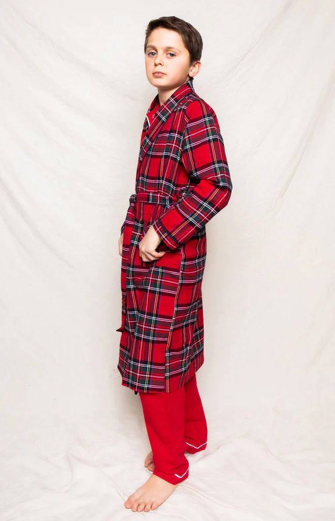 Three-quarter side view of Children’s Imperial Tartan robe on child, red tartan plaid with belted waist and mid-calf length on plain white background