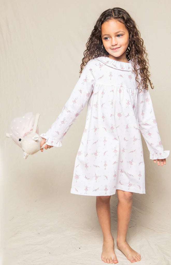 Front view of Children’s Sugar Plum Fairy Scarlett nightgown on a girl model showing long sleeves, ruffle collar, and pink ballerina print