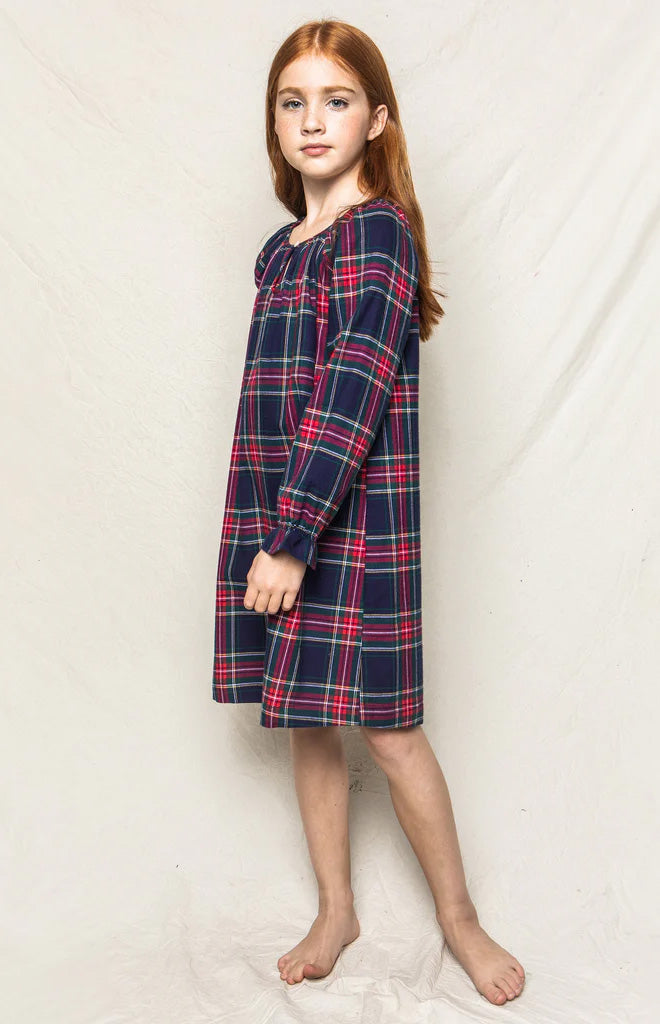 Side view of Children’s Windsor Tartan Delphine nightgown on model, navy and red, gathered sleeves and knee-length