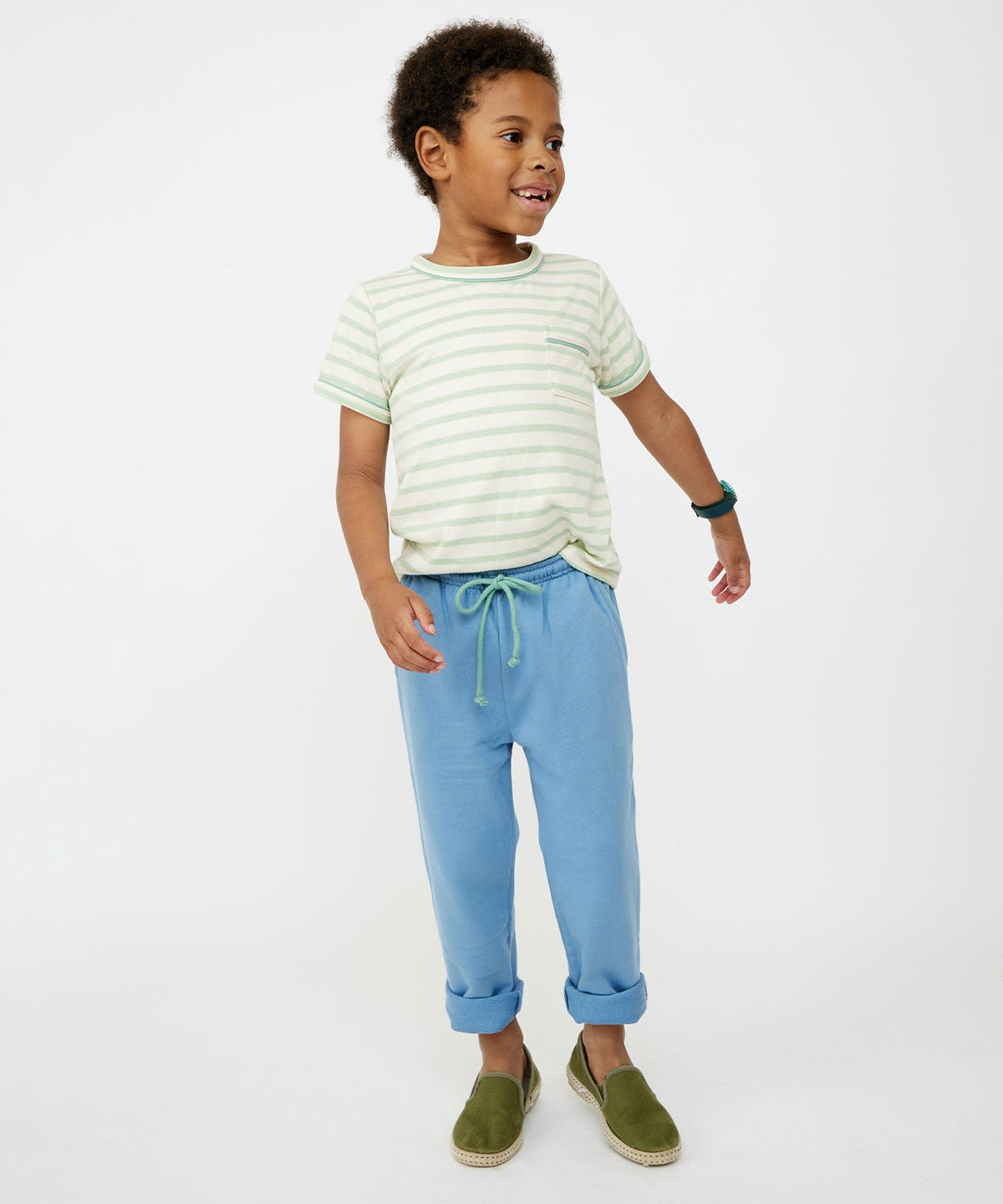 Front view of Chris Jogger in Dusty Blue worn by child model showing green drawcord, rolled cuffs, and elastic waist