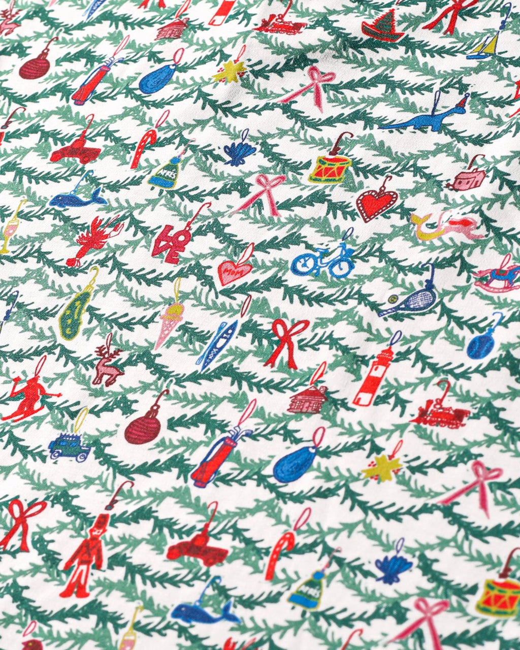 Close-up of Oh Christmas Tree Zip Baby Onesie showcasing hand-drawn evergreen and whimsical ornament print on white fabric