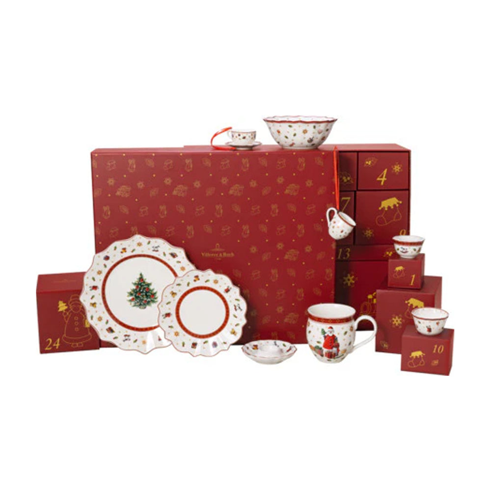 Front view of Villeroy & Boch Christmas Toys Memory advent calendar showcasing numbered red drawers and porcelain plates, bowls, and a mug on white background