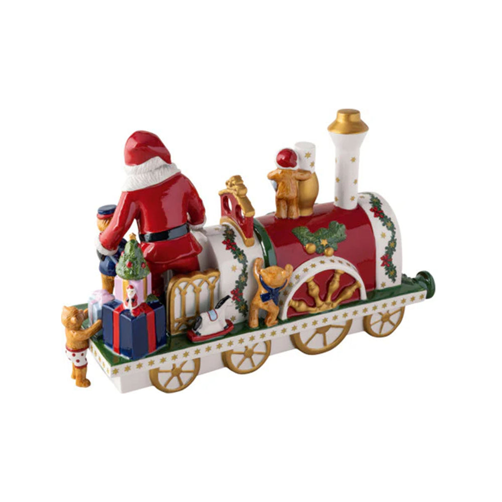 Angled view of porcelain Christmas locomotive with hand-painted multicolor and gold accents, Santa and toy details on white