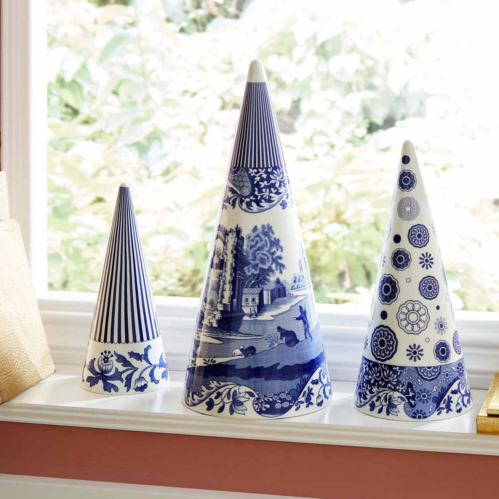 Front view of 9-inch Blue Italian ceramic Christmas topiary shown with two matching cones on a sunlit windowsill