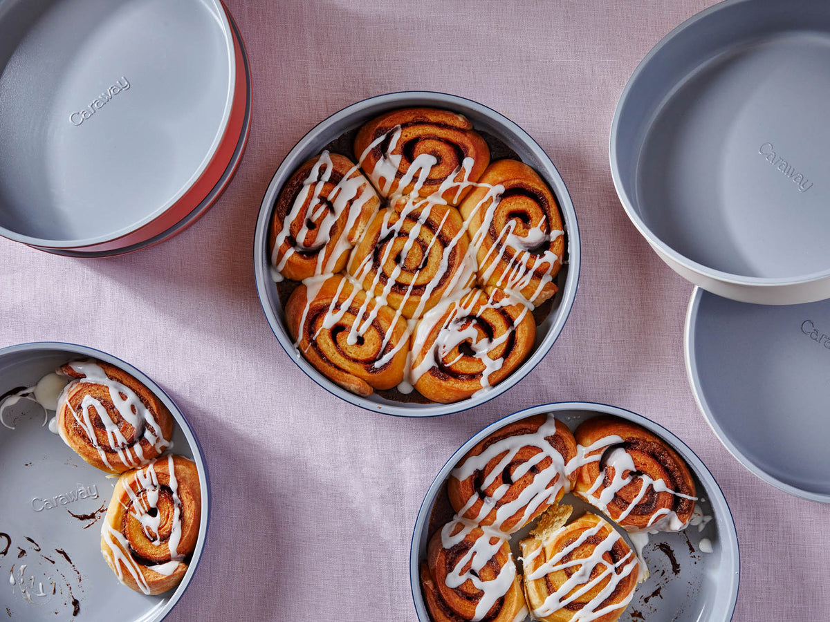 Overhead view of Circle Pan with iced cinnamon rolls showing smooth ceramic interior and reinforced rim on pink linen