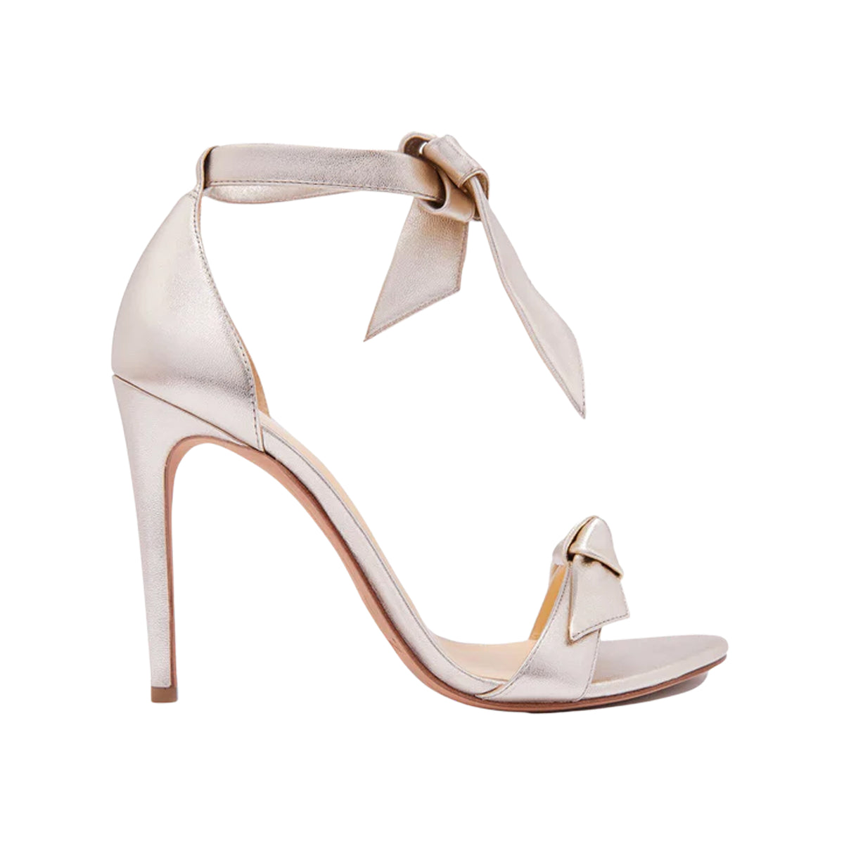 Side view of Clarita 100 in Golden Leather showcasing two bow accents and a stiletto heel with a white background