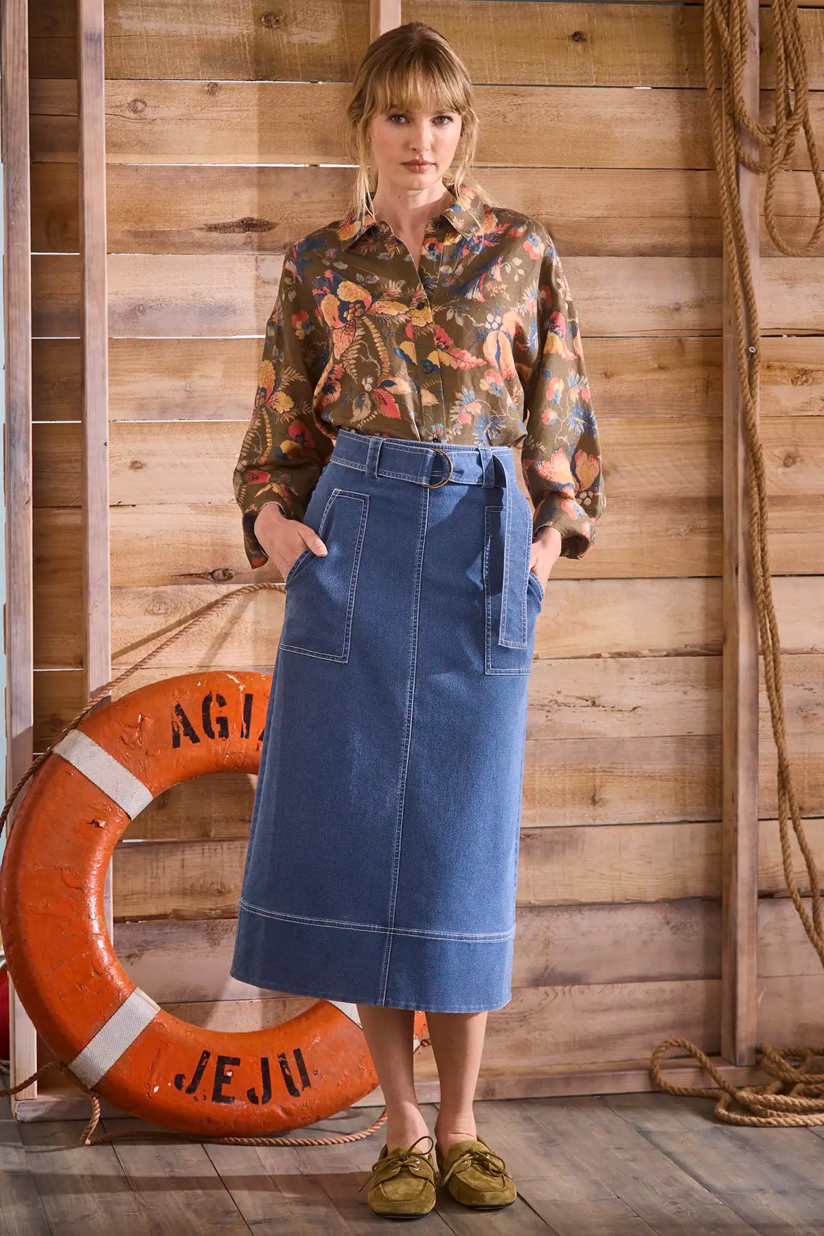 Denim midi skirt framed by patch pockets with crisp topstitching and a removable belt with a D-ring.