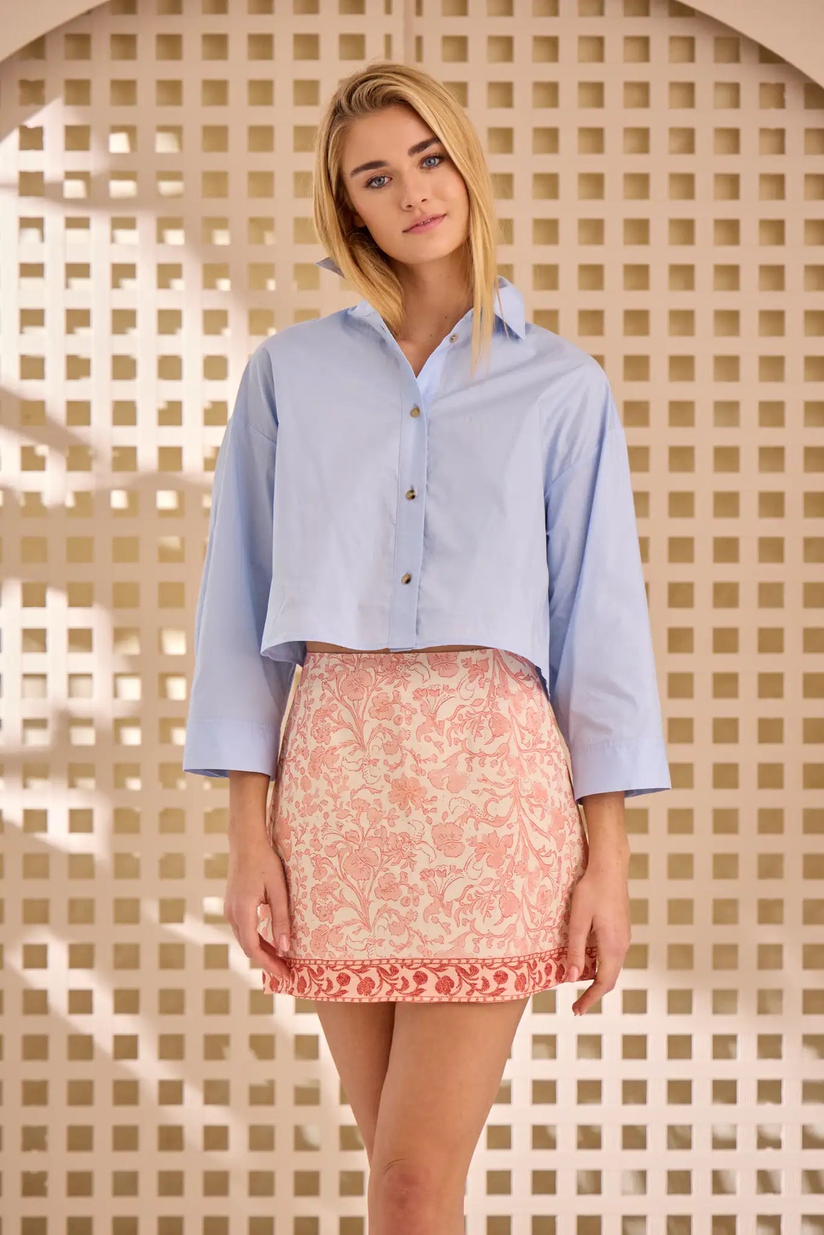 The Clarke Shirt has a cropped, boxy fit, a collared neckline, a button front and wide sleeves.
