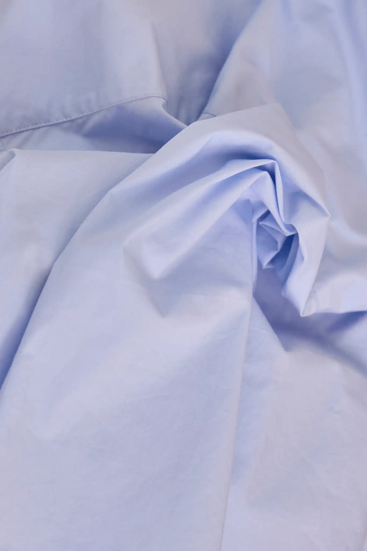 The Clarke Shirt has a cropped, boxy fit, a collared neckline, a button front and wide sleeves.
