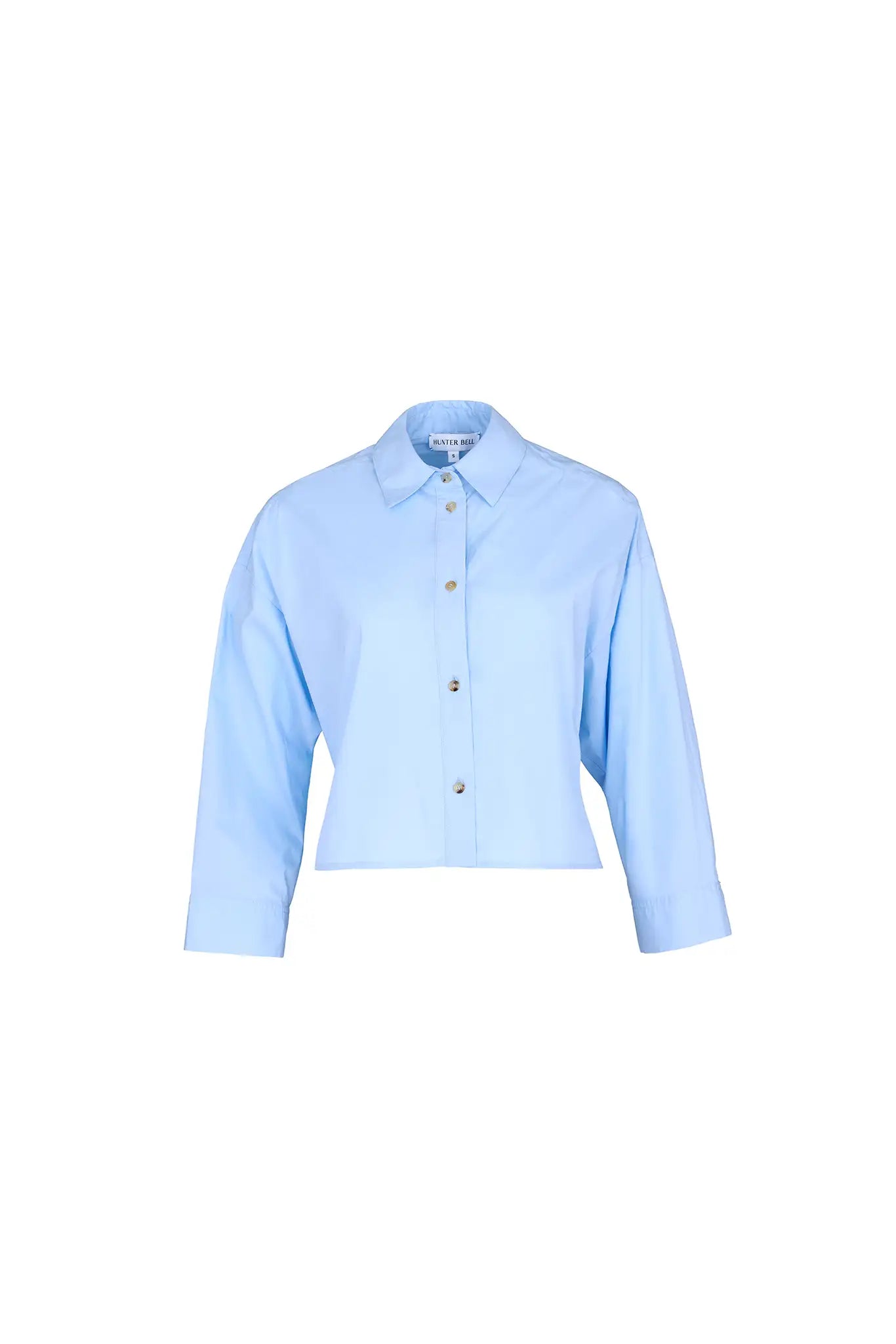 The Clarke Shirt has a cropped, boxy fit, a collared neckline, a button front and wide sleeves.
