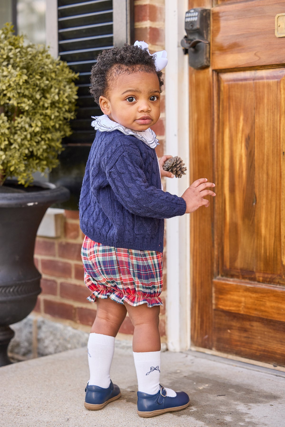 Little english classic children's clothing, cashmere blend cardigan in navy,  double london blouse with navy stitching on collar, bow bloomers in middleburg plaid, knee high socks with navy bow motif, fall outfit for little girl 