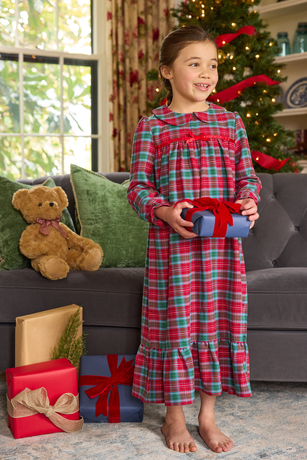Girl wearing Classic Nightgown in Highlands Tartan, red and green plaid, Peter Pan collar and fixed chest bow, Christmas living room