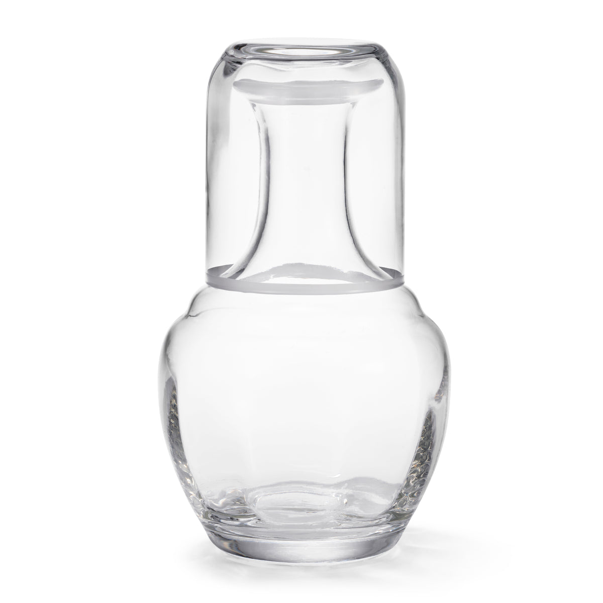 Front view of Claudette Bedside Carafe and Tumbler with clear crystal, white rim, and subtle fluted body