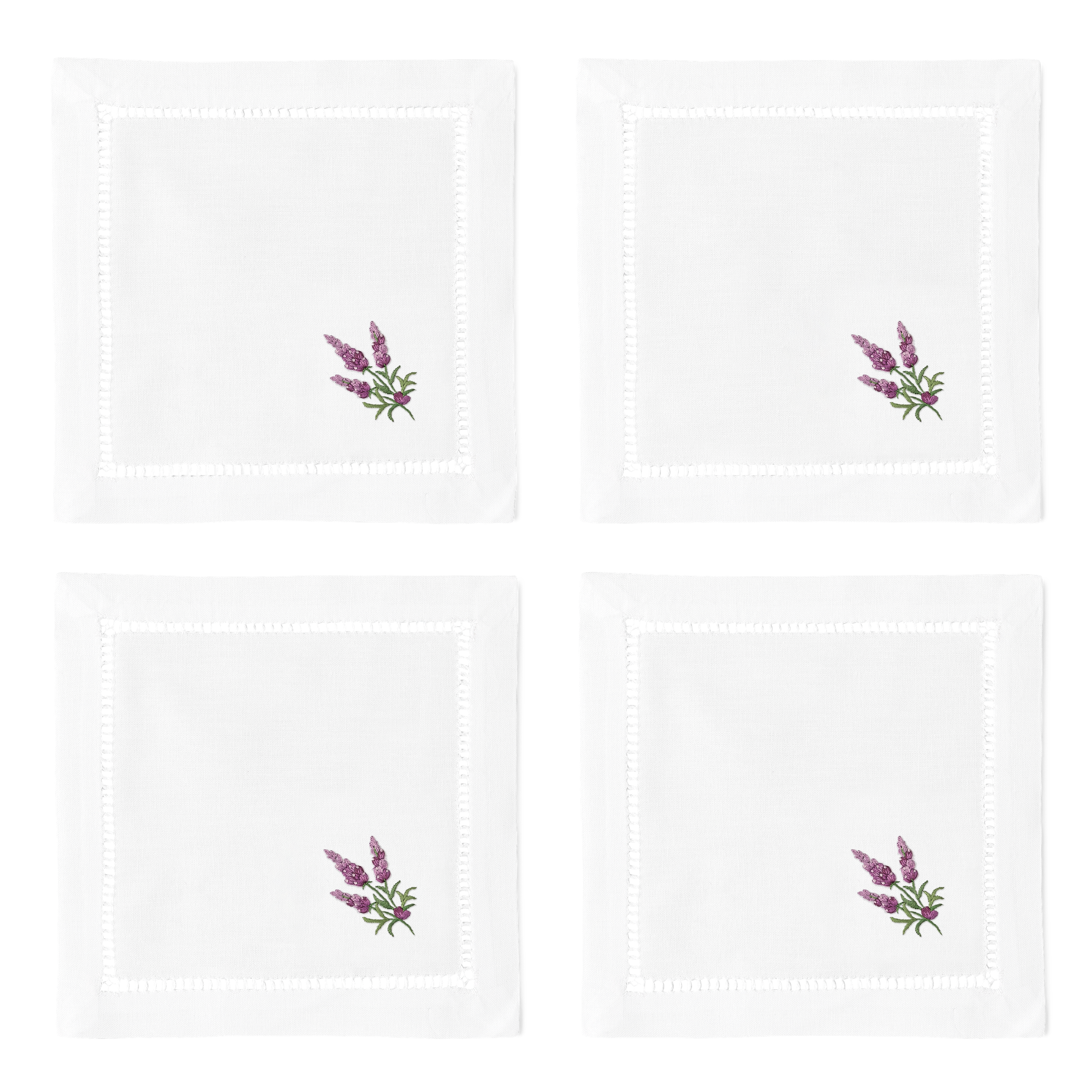 4 white cocktail napkins. Embroidered in the bottom right corner of each is a bundle of lavender