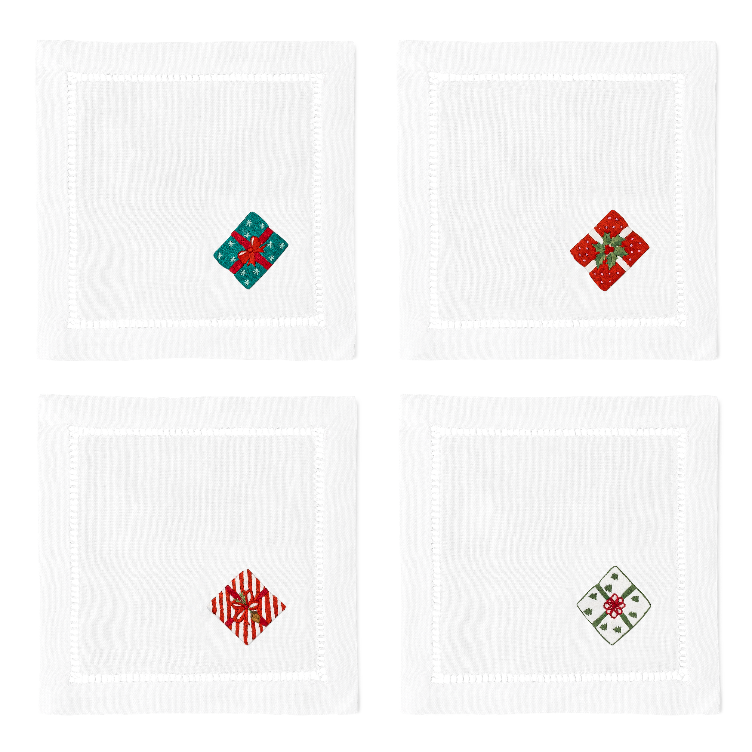 4 white cocktail napkins with a hemstitch border. A different wrapped gift is embroidered on the bottom right corner of each