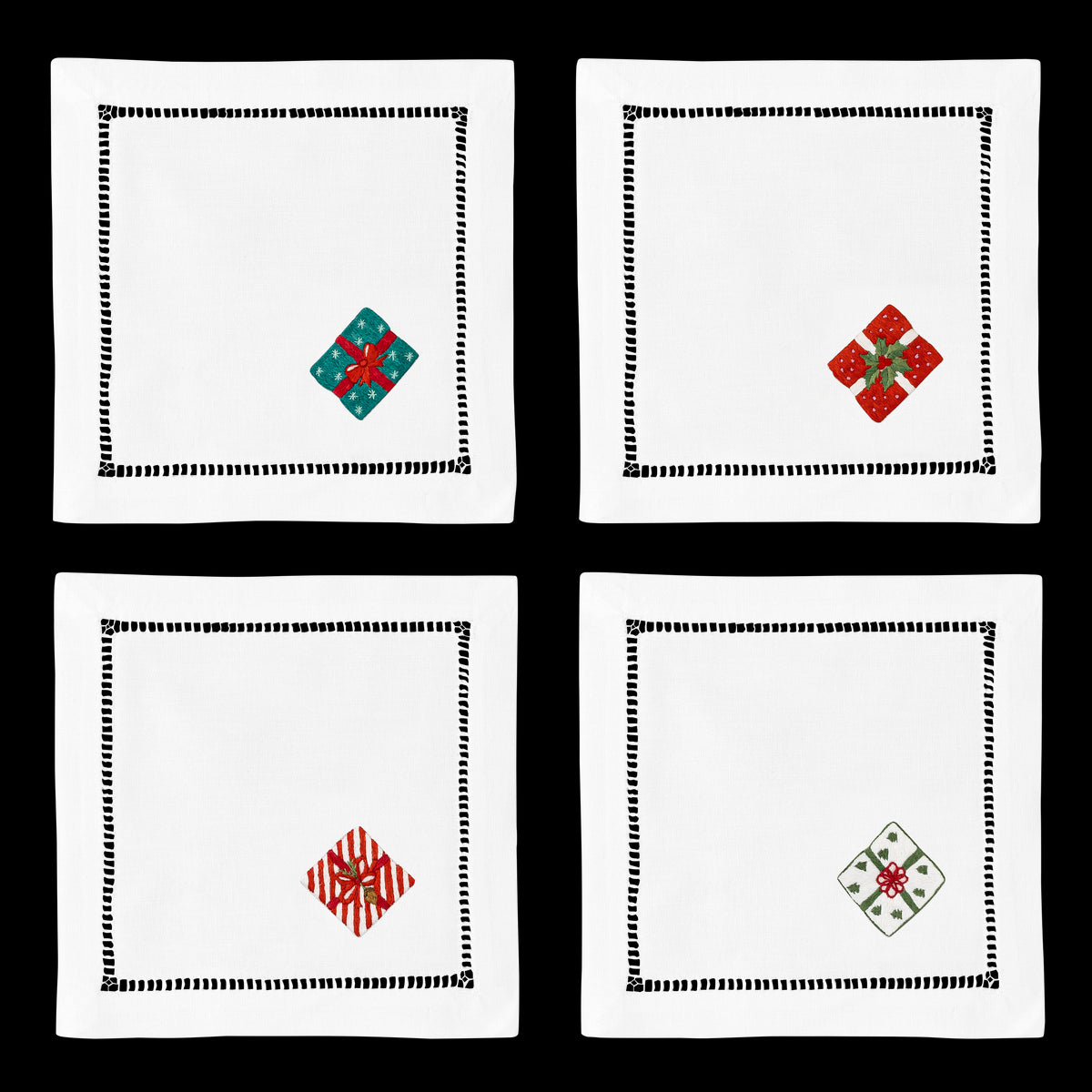 4 white cocktail napkins with a hemstitch border. A different wrapped gift is embroidered on the bottom right corner of each