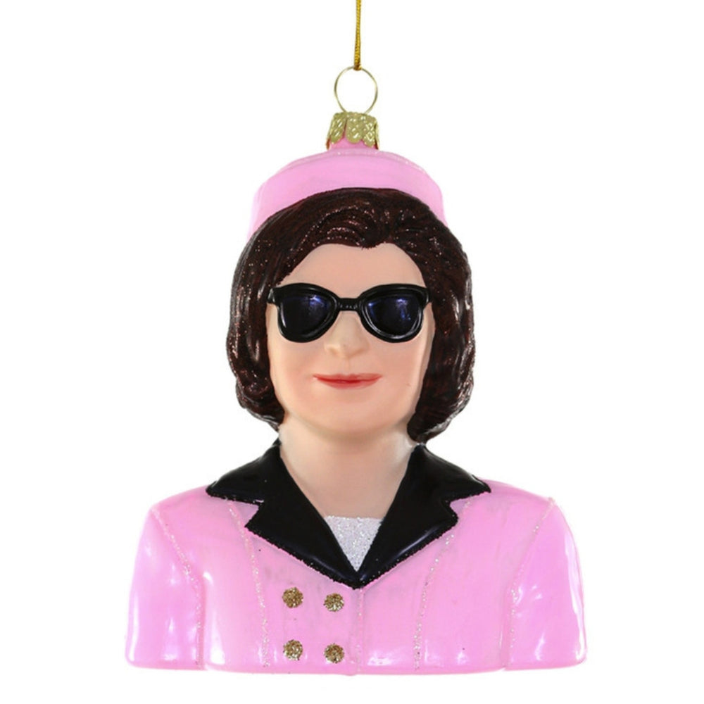 Front view of Jackie Kennedy ornament showcasing a pink pillbox hat, black sunglasses, and pink suit against a white background