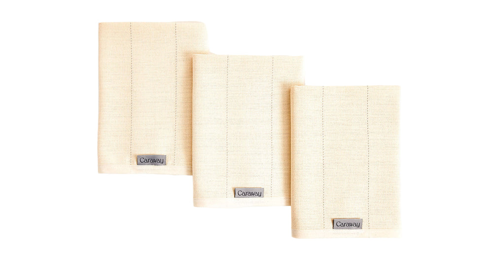 Front view of Caraway tea towels, set of three in cream showing woven texture and Caraway label on white background