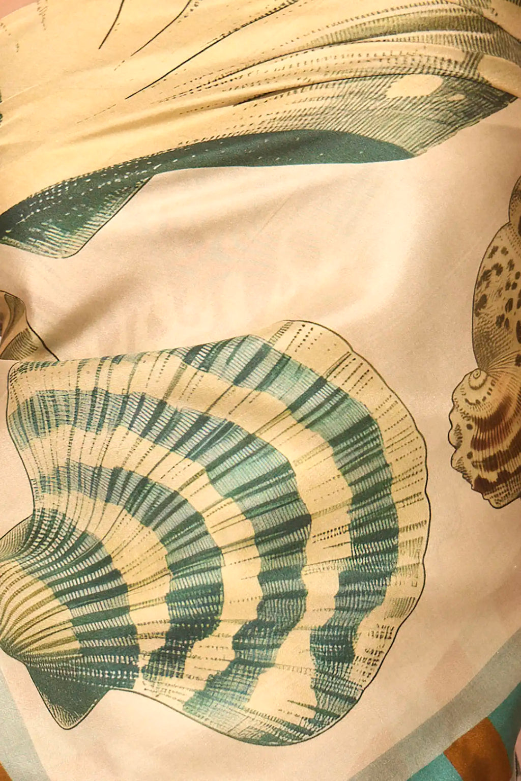 Close up of the Coquille Scarf in Somers Shell Cream.
