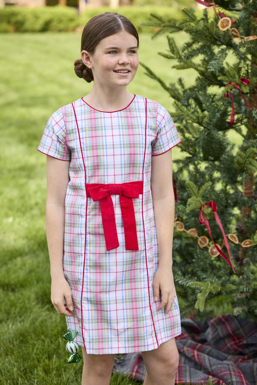 Little English classic children's clothing. Girls A-line dress in red and green plaid with red bow and red piping detail for the holidays