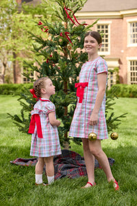 Little English classic children's clothing. Girls A-line dress in red and green plaid with red bow and red piping detail for the holidays.  Matching toddler girl dress with ruffled peter pan collar and bow tie sash in back.
