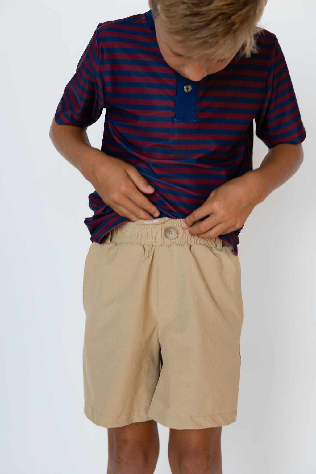 Front view of khaki Dress Short showing pull-on elastic waistband and decorative button, white background