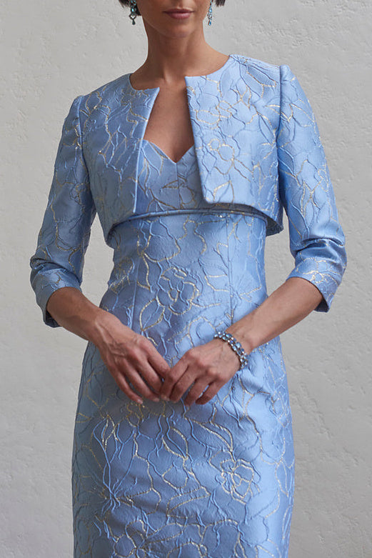 Front view of Cropped Jacket in Pale Blue showcasing fitted cropped silhouette and brocade with model wearing it over matching gown