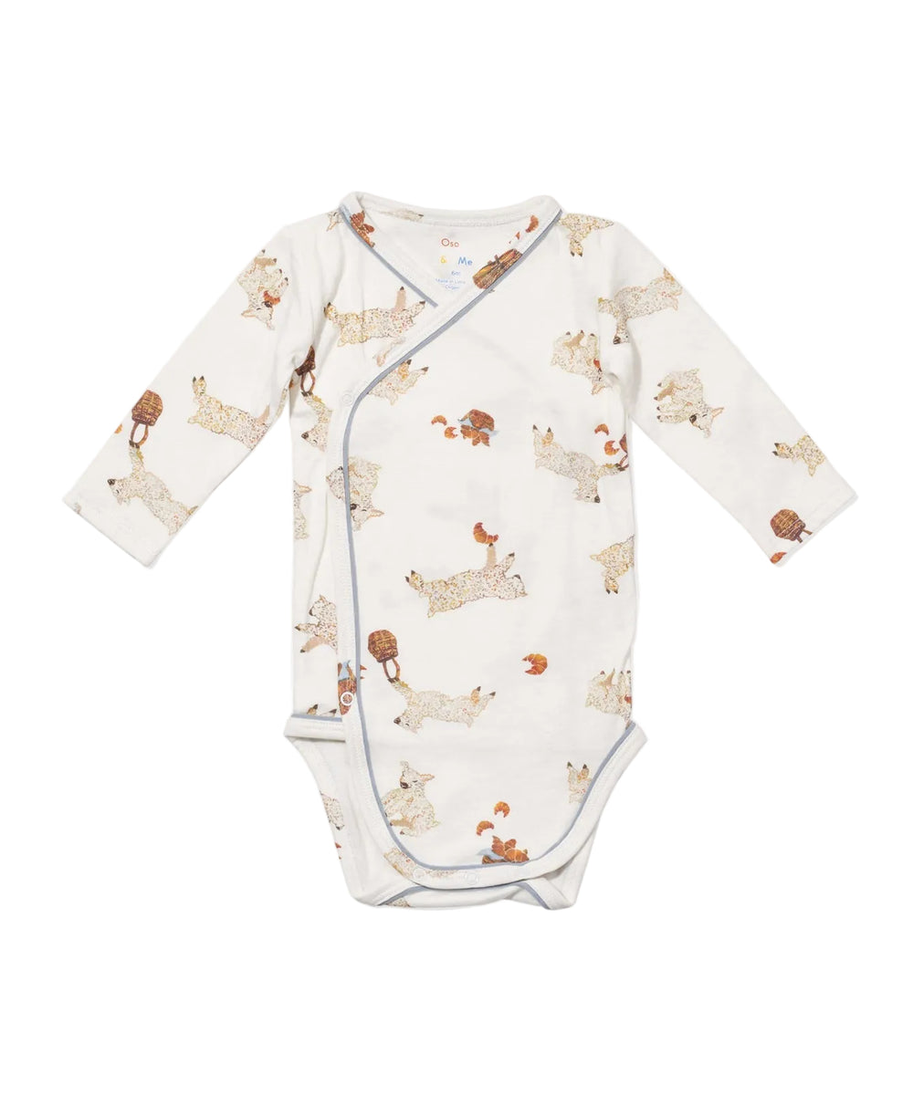 Flat lay front view of Crossbody One-Piece in Le Lamb print showcasing wrap-style opening, long sleeves, and snap closure on white background